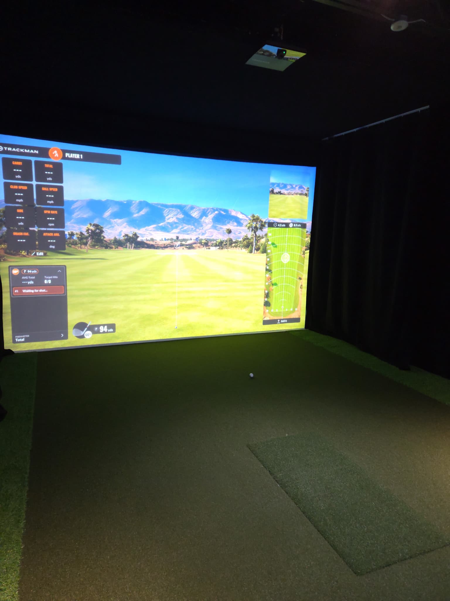 The Sim Box Haslett practice bay with a projected driving range