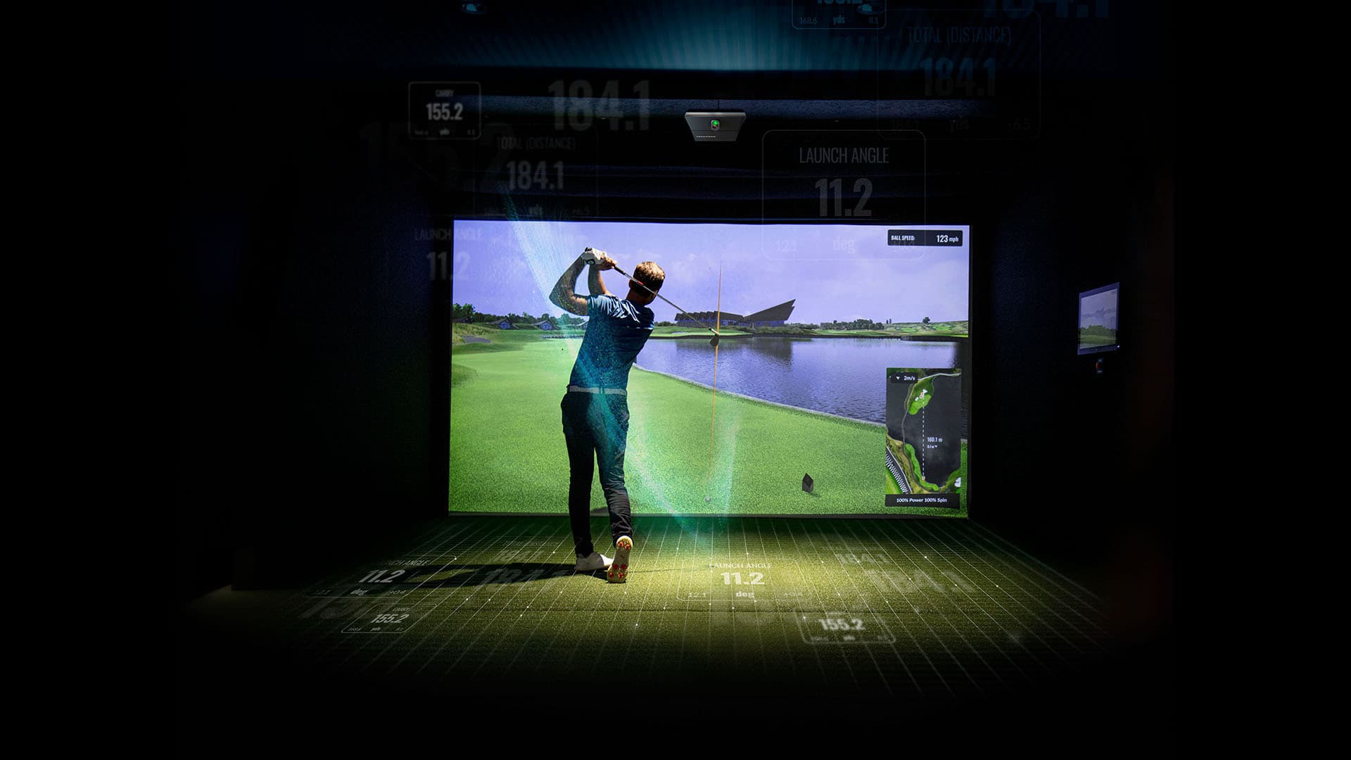Golfer following through in an indoor simulator — Trackman media-kit photography